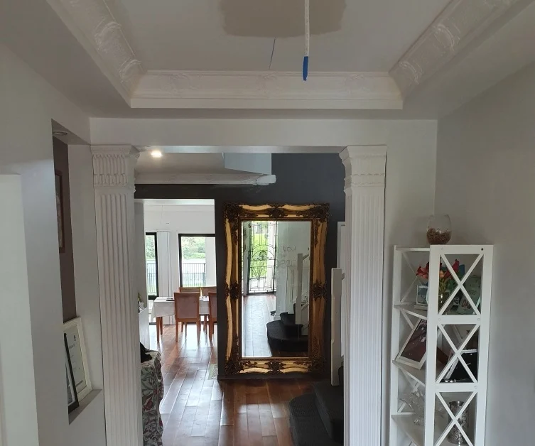 Renovated hallway with plaster arch and cornices